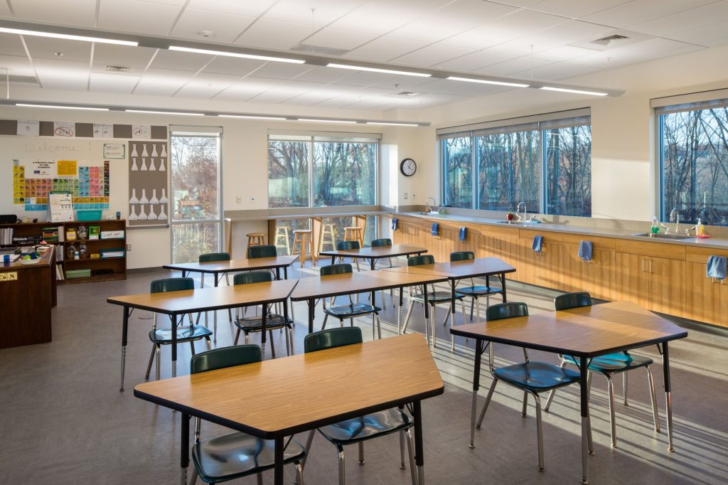 A flexible school classroom with bright windows, flexible seating, and STEM focused spaces