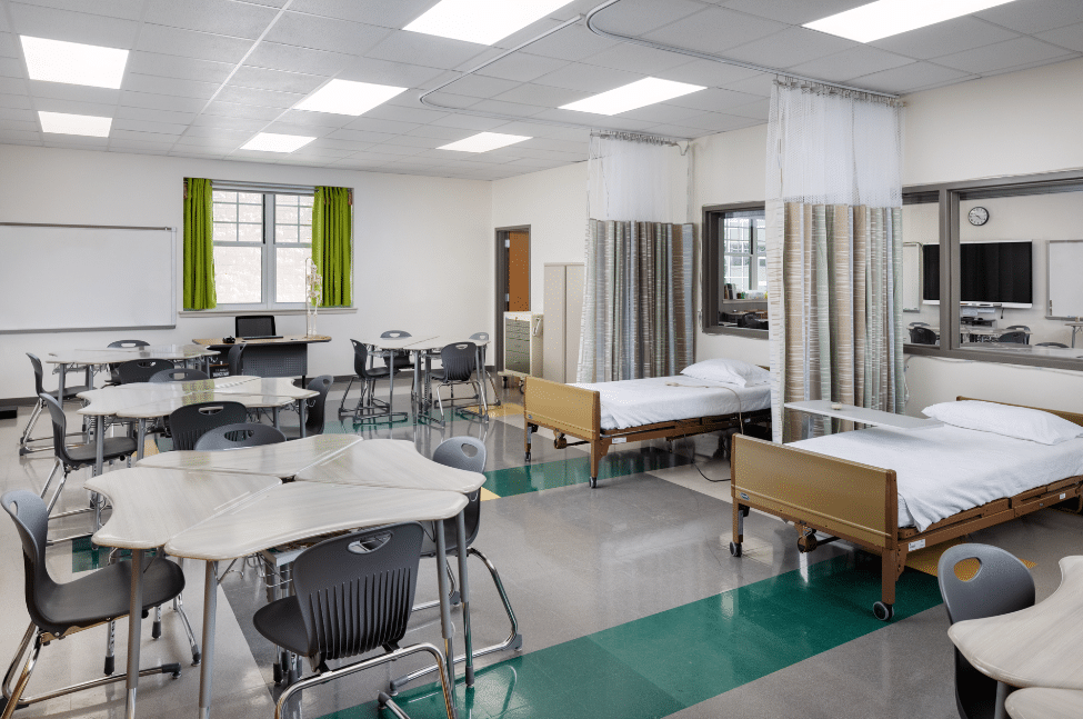 Health Sciences Classroom with hospital beds, collaborative tables and STEM technology